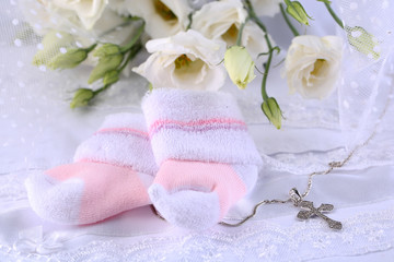 Baby shoe, flowers and cross for Christening