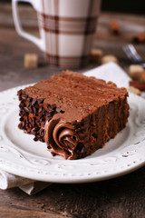 Tasty piece of chocolate with lump sugar and cinnamon sticks