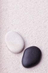 Fototapeta na wymiar Black and beige stones in the relaxing zen garden sand