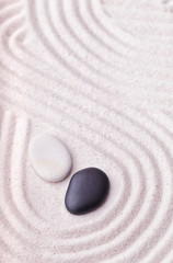 Fototapeta na wymiar Black and beige stones in the relaxing zen garden surrounded by