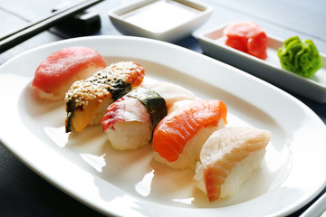 Sushi on plate on wooden table background