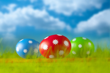 Colored Easter eggs on blue sky background