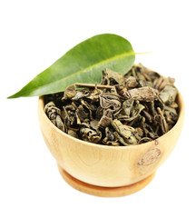 Wooden bowl with green tea with leaf isolated on white