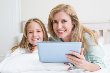 Fototapeta na wymiar Happy mother and daughter using tablet