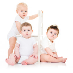 Group of cute  babies, crawling, over white. playing babies