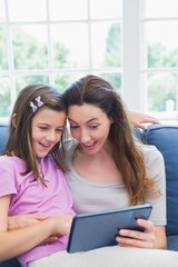 Mother and daughter using tablet pc