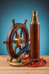 Fototapeta na wymiar maritime adventure old anchor and brass telescope