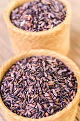 raw brown sticky rice on bamboo basket