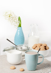 Hyacinth Flowers In Vase. Amaretti Biscuits. Cup Of Tea