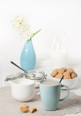 Hyacinth Flowers In Vase. Amaretti Biscuits. Cup Of Tea