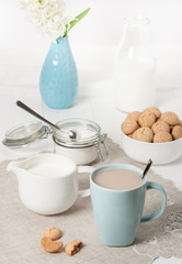Hyacinth Flowers In Vase. Amaretti Biscuits. Cup Of Tea