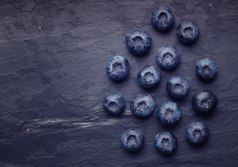 A bunch of delicious blueberry on slate of tile