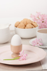 Obraz na płótnie Canvas Hyacinth Flowers. Amaretti Biscuits. Boiled Egg. Cup Of Tea