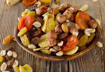 Nuts and dried  fruits on a wooden background