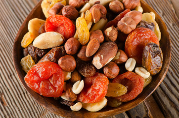 Healthy Mix nuts and dried  fruits on a wooden background