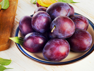 Plums on a  wooden table