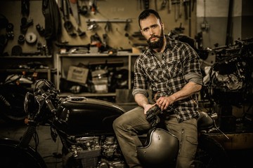 Fototapeta na wymiar Rider and his vintage style cafe-racer motorcycle 