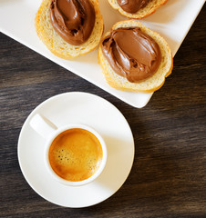 Toasts with chocolate spread and espresso coffee.