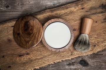Shaving brush and soap on a luxury wooden background