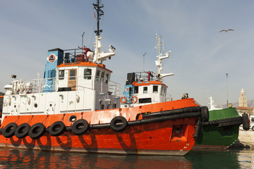 Tug boat against dramatic blue sky