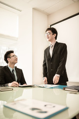 Businessman standing in front of colleagues during a meeting