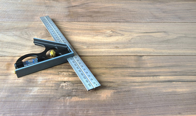 Right angle squaring tool on a wallnut background