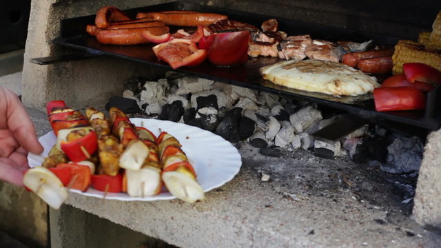 Barbecue grill with kebab meat, sausages, vegetable and cheese.
