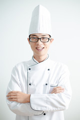 Young chef with arms crossed smiling