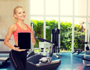 smiling woman showing tablet pc blank screen