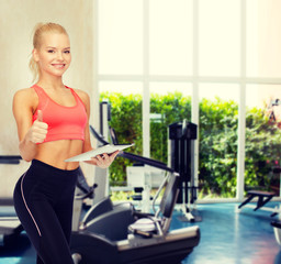 Fototapeta premium smiling sporty woman with tablet pc computer