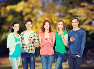 smiling students with smartphones