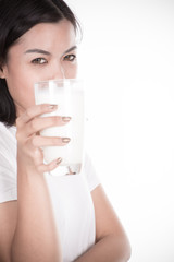 Laughing young woman with a glass of milk