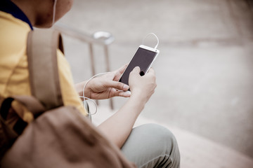 students sitting on stairs with their smartphones