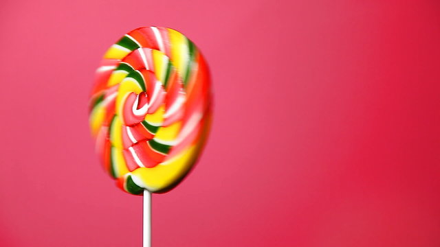 lollipop in the form of an round on a pink background
