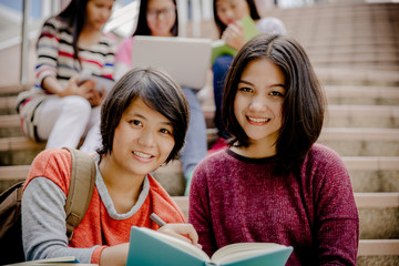 group of happy teen high school students outdoors