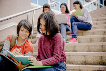 group of happy teen high school students outdoors