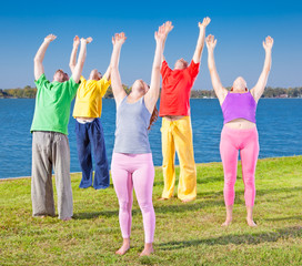 Obraz premium Young people practice Yoga asana on lakeside.