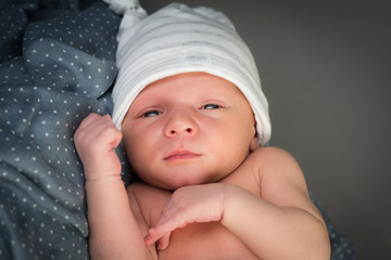 beautiful newborn baby boy isolated on gray a background