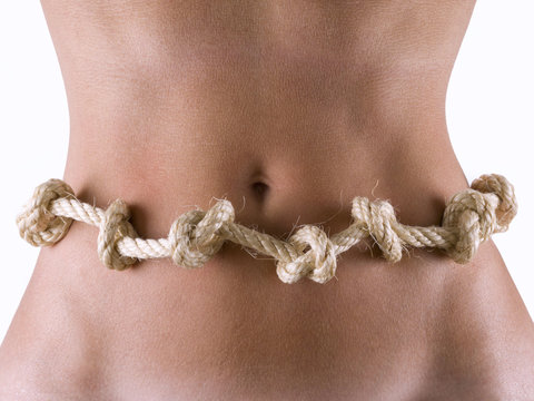 Woman's abdomen with a knotted rope, around the waist.