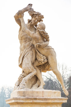 Statue of nymph catching grapes from satyr's hand in Warsaw