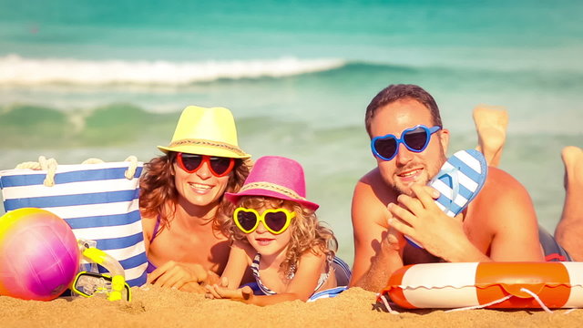 Happy family having fun at the beach. Summer vacations concept