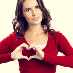 Young woman showing heart symbol gesture