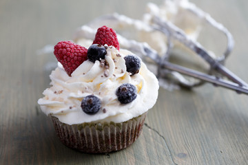 Muffin with whipped cream and frozen berries