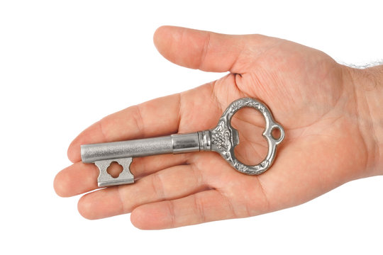 Hand with retro silver key
