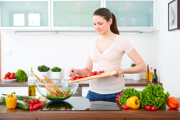 Young woman in the kitchen prepare salad II