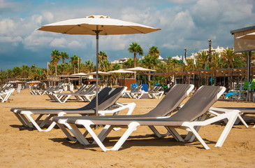 Beach with deckchairs and umbrellas in Salou in Spain