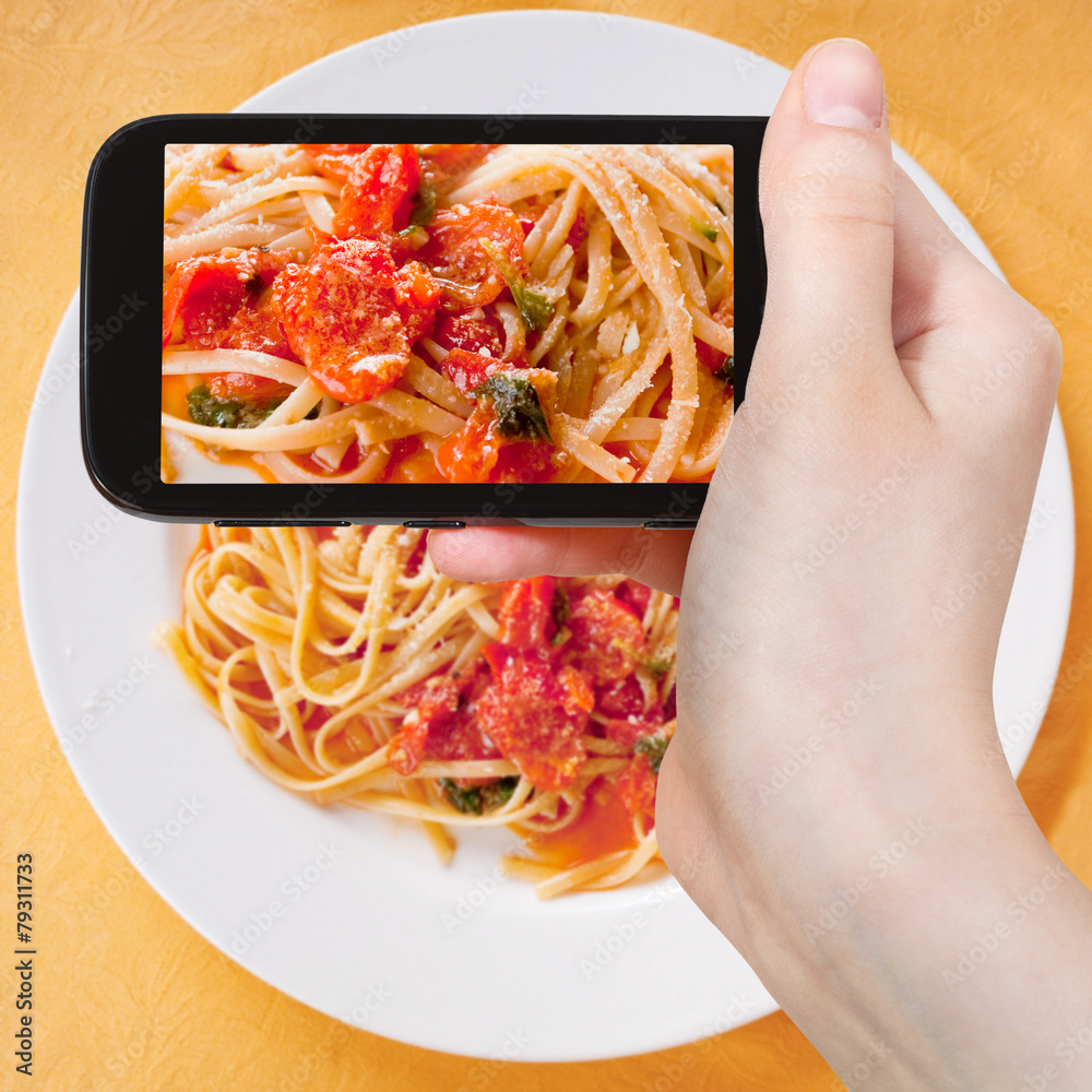 Wall mural tourist taking photo spaghetti with tomato sauce