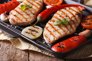 Hot chicken with peppers and tomatoes in a skillet grill