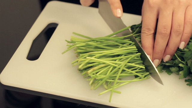 woman cuts fresh parsley