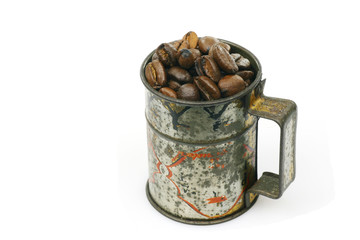 measuring cup with coffee beans on a white background